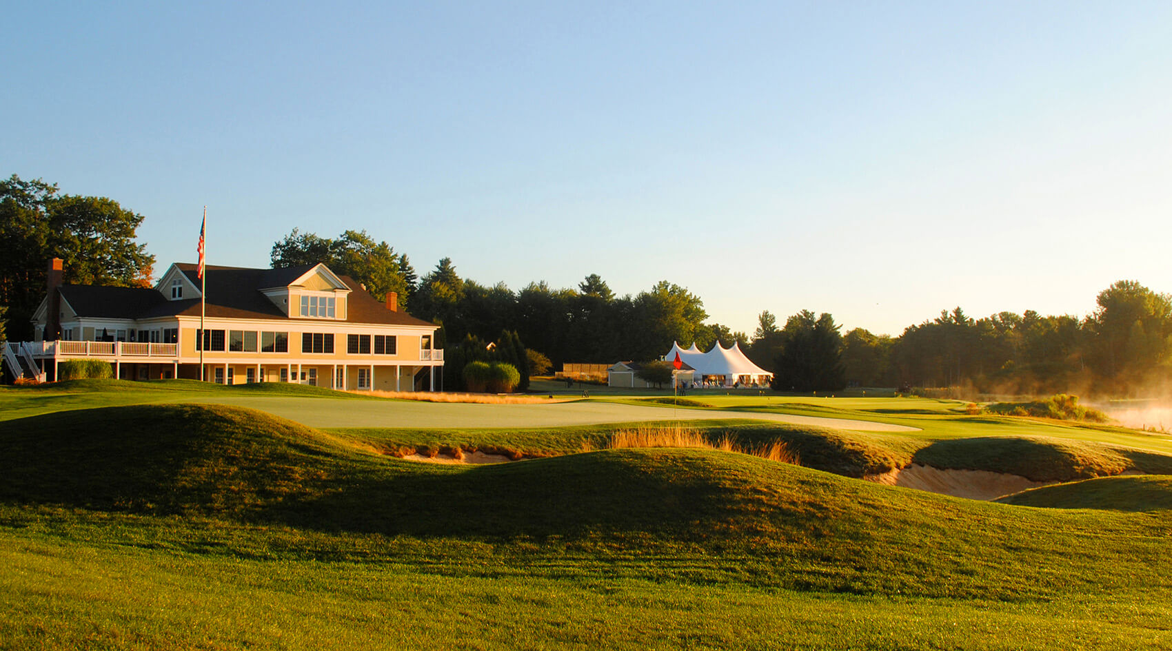 Falmouth Country Club clubhouse and 18th green at sunset
